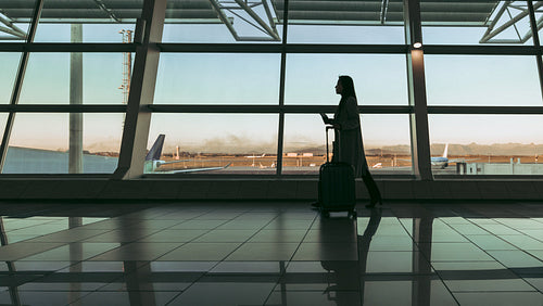 Silhouette of a traveler walking at airport