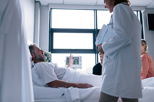 Female doctor visiting patient in hospital room