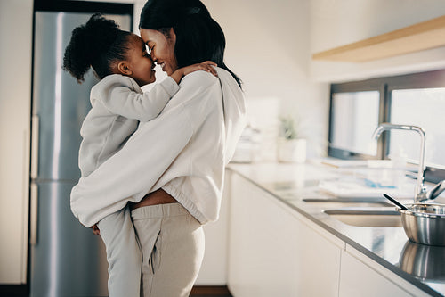 Loving mother and daughter relationship, woman carrying her daughter