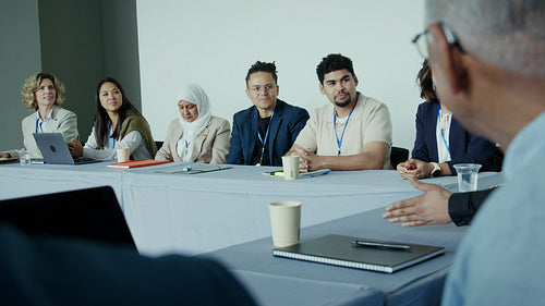 Business professionals listening attentively during a conference discussion