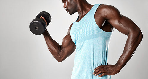 Mixed race man exercising with hand weights