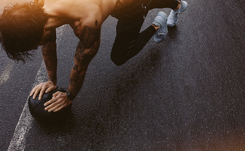Man doing push ups with a medicine ball