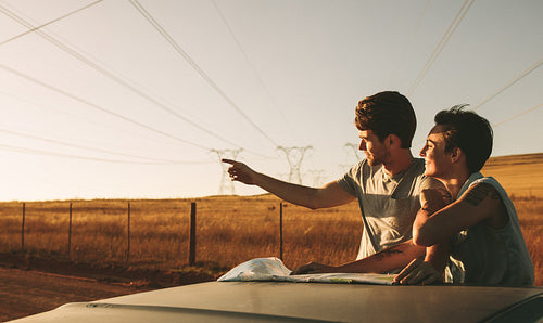 Couple on a road trip looking at map for navigation