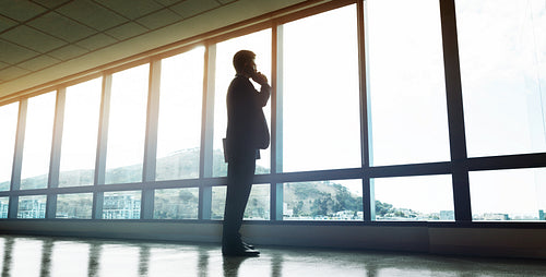 Businessman talking on mobile phone in office