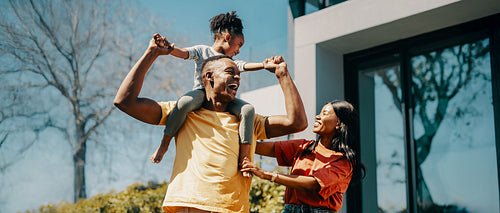 Happy African family spending time together outdoors