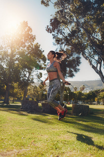 Young woman skipping with a jump rope 
