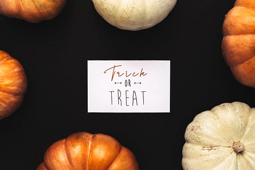 Orange and white pumpkins with trick or treat card
