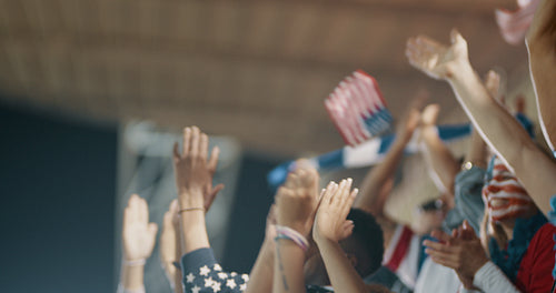 Group of USA supporters applauding in stadium