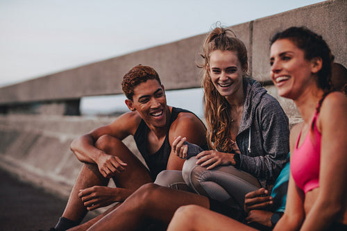Multi-ethnic group of fitness people resting after workout
