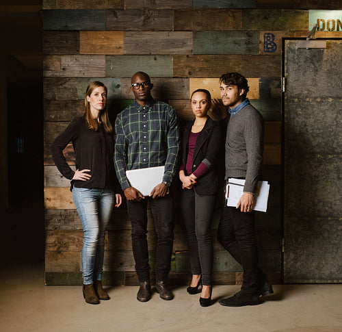 Multiracial creative team posing for camera in office