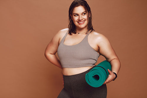 Plus size female model after yoga workout