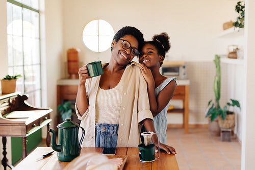 A mother and daughter morning: Woman enjoying drip coffee and her daughter's company at home