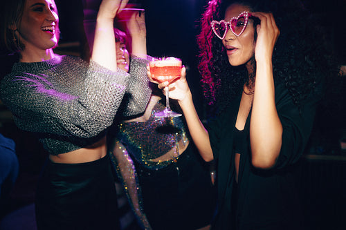 Friends enjoying a night out with drinks and joyful celebrations