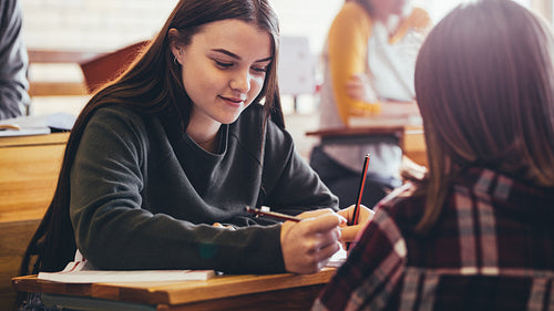 Girls sitting at desk in a classroom