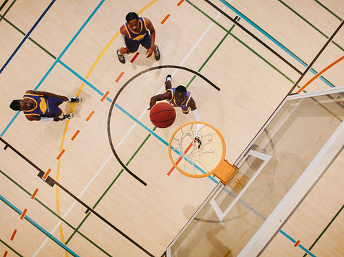 Basketball players shooting on a court