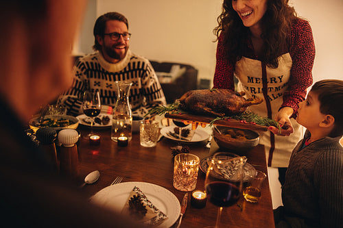 Woman serving thanksgiving turkey for family dinner
