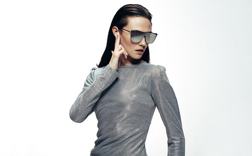 Woman in sliver outfit and mirrored glasses 