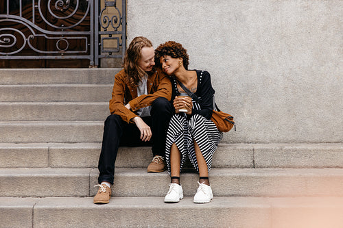 Affectionate couple enjoying a moment together on city steps
