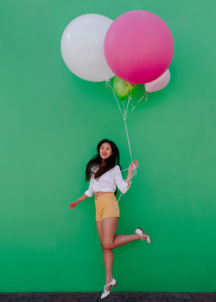 Party woman holding a bunch of balloons