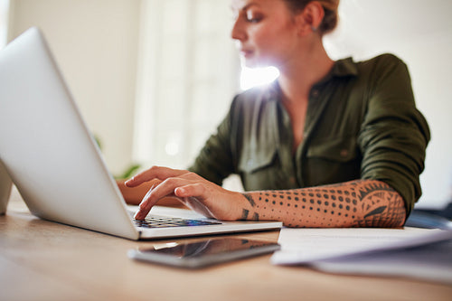 Woman working on laptop at home