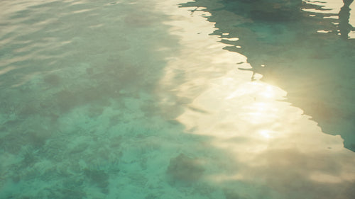 Beautiful clear turquoise ocean water with shimmering sunlight reflecting on the surface