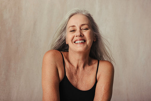 Mature woman proud of her naturally aging body