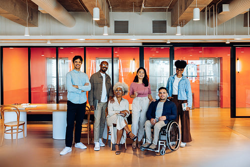 Diverse team stands together in modern office