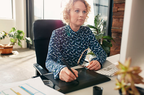 Female graphic designer working at her desk