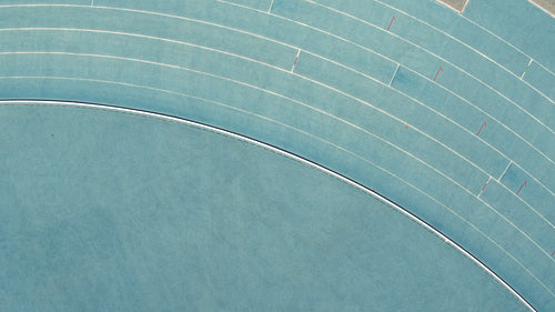 Female athlete practicing on race track in stadium