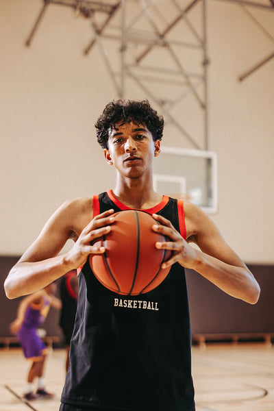 Quiet confidence: Male athlete stands with the ball