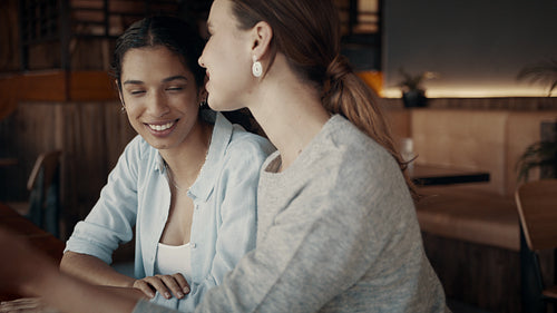 Two friends having a great time at a cafe