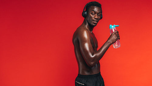 Man taking drinks break after workout