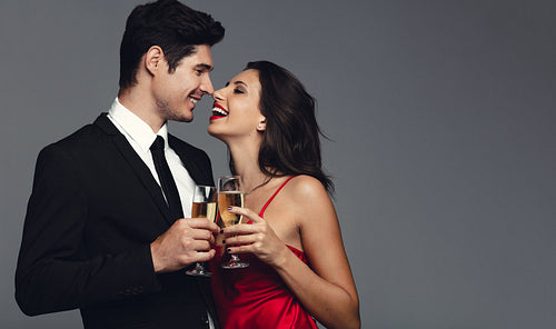 Happy young couple having champagne