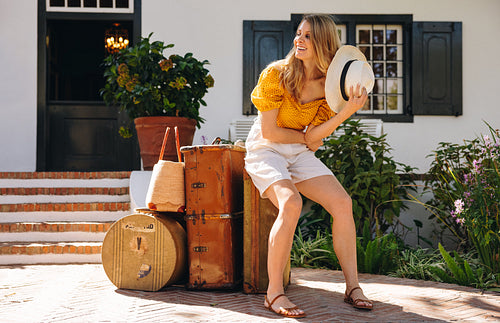 Tourist woman looking out for her ride outside a hotel