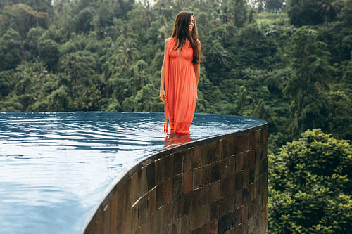 Young woman in swimming pool looking away at view