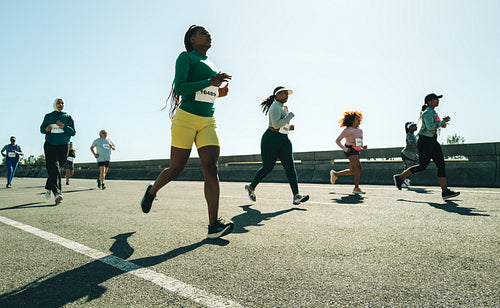 Diverse group of women participating in a running race outdoors
