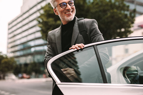 Businessman getting off a cab