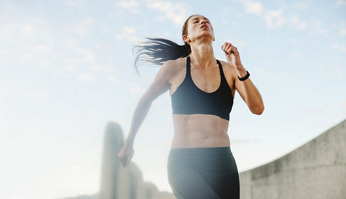 Fitness woman running outdoors in morning