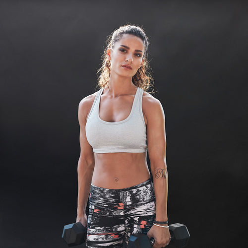 Strong and muscular female doing bodybuilding training