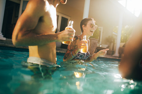 Smiling woman at pool party with friends