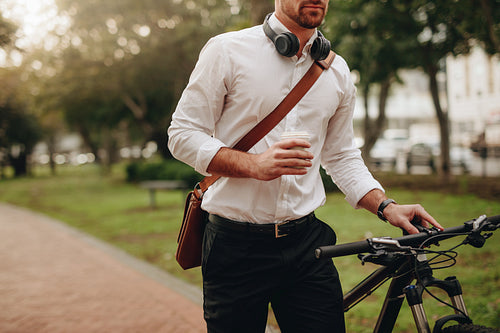 Man walking on street with his bicycle