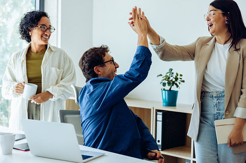 Business colleagues celebrate success with a high five