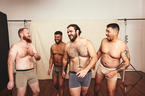 Cheerful men laughing in a modern studio