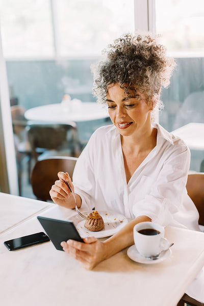 Mature businesswoman having a video call in a cafe