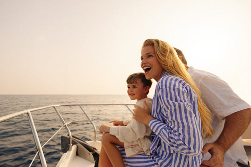 Happy family enjoying sailing holiday on sunny day