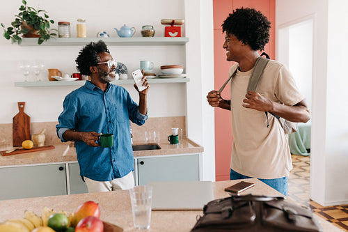 Morning at home: Father and son chatting in the kitchen