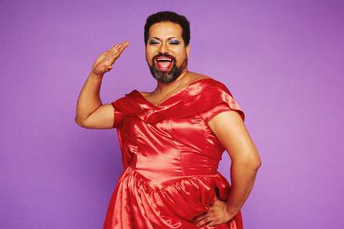 Drag performer singing in female clothing