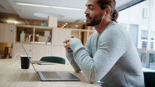 Young freelancer attends a virtual meeting from a coworking space