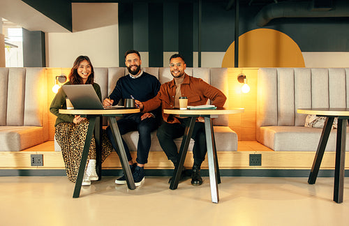 Happy businesspeople working in a modern lobby