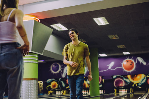 Couple playing in bowling club